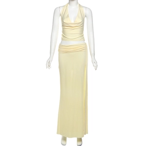 Detail of light yellow halter top and high-waisted skirt with pleated waist details