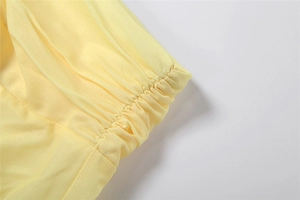 Detailed view of yellow floral skirt featuring smocked elastic waist and twill fabric texture