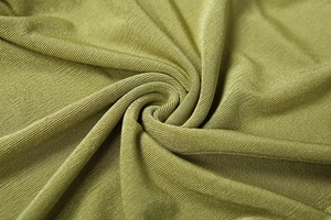 Detailed macro view of olive green ribbed knit fabric with soft texture and vertical stripes