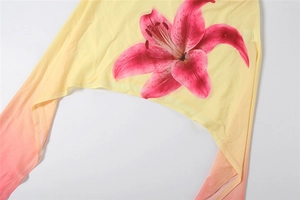 Close-up of floral print on yellow gradient skirt showing detailed pink lily pattern