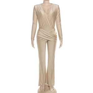 Detail of waist-slimming cross-pleated design on champagne gold V-neck jumpsuit