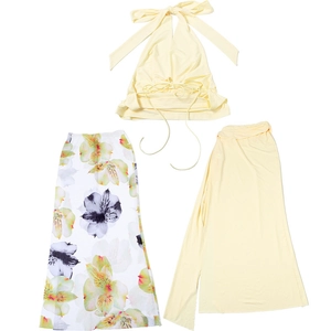 Flat lay of a three-piece floral print set with yellow halter top and long skirts