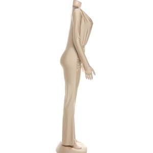 Detail view of champagne V-neck long sleeve jumpsuit with waist ruching and slim fit style