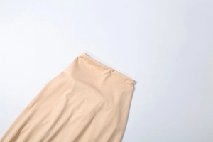 Close-up of beige high-waisted seamless fabric detailing the smooth elastic texture