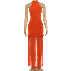Detail of orange halter dress featuring bohemian woven rope trim and long fringe hemline