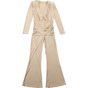 Detail of elegant deep V-neck and criss-cross pleated waist on this slim jumpsuit