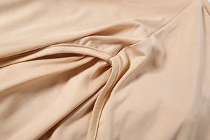 Detailed view of nude brown bodysuits soft fabric with reinforced double stitching
