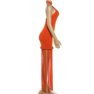 Detail of orange halter dress showing intricate woven rope texture and long fringe hem