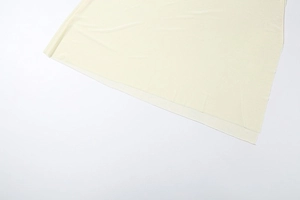 Close-up of light beige halter neck fabric texture and clean edge cutting detail