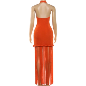 Detail of orange halter dress with open back and long decorative fringe at the hemline