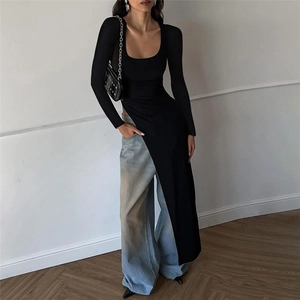 Close-up of black long sleeve top featuring a high side slit and irregular hem design