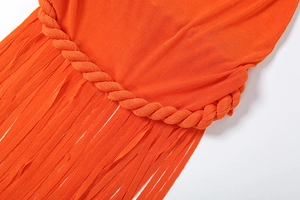 Detailed macro shot of bright orange dress featuring twisted rope and long tassel fringe