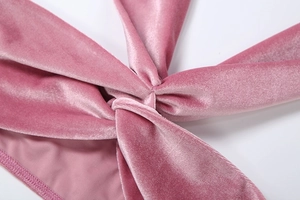 Detail aus rosa Samtstoff mit Knotendesign und weichem Seiden-Finish-Effekt