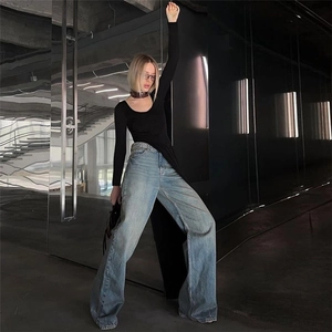 Detail of slim fit long sleeve top paired with high waist wide leg denim jeans