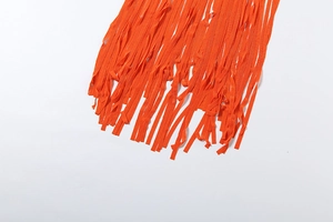 Detailed view of vibrant orange fringe tassels on the back of a backless halter dress