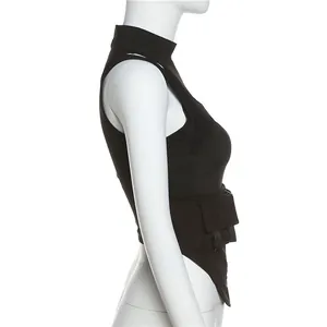 Detail view of black utility vest with side flap pocket and buckle strap decor