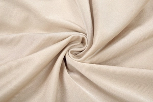 Macro shot of champagne gold fabric showing ribbed texture and soft metallic luster