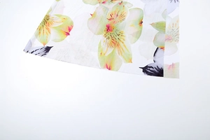 Detail close-up of the elegant yellow lily floral print and soft fabric of the three-piece set