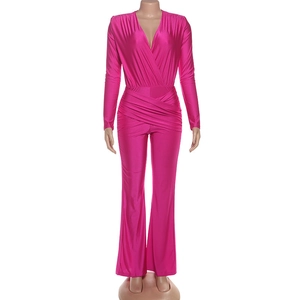 Close-up of deep V-neck and ruched waist detail on a vibrant rose pink jumpsuit