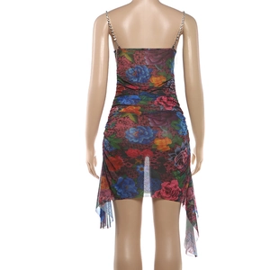 Macro detail of the metal chain strap on a colorful floral mesh ruched dress