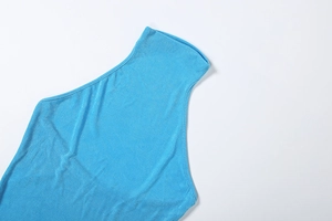 Detail shot of the sky blue halter neck design and soft knit texture of the dress