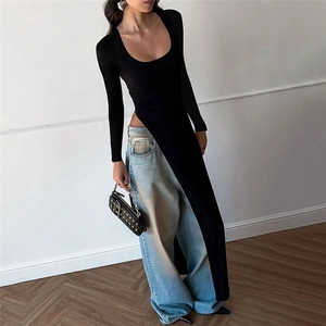 Detail of slim fit long sleeve top with deep U-neck and high side slits on a model