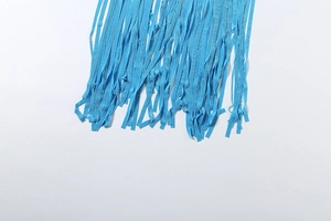 Close-up of light blue fringe detailing on backless halter dress showing texture