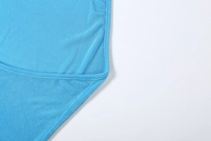 Close-up of sky blue backless dress showing fine stitching and vertical knit texture