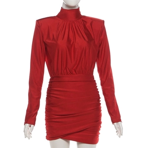Detalle del vestido de satén rojo fruncido con cuello alto y elegante textura plisada
