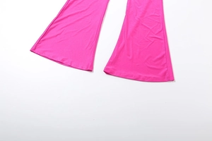 Detail of rose pink flare pants leg featuring stretchy fabric and wide leg silhouette
