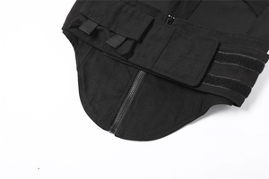 Detail of black tactical vest featuring durable fabric, heavy zippers and functional D-rings