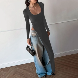 Detail of slim fit black long sleeve top featuring a deep U-neck and high side slits