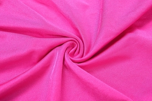 Macro shot of rose pink knit fabric texture with silky sheen and soft drape detail