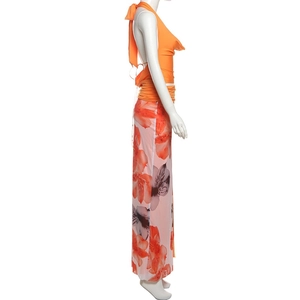 Detail of orange halter top and pink high slit floral print skirt on mannequin