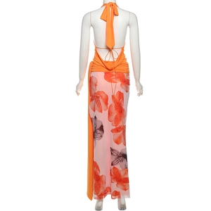 Back view of a backless halter top and floral maxi skirt set in vibrant orange colors