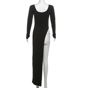 Detail of a black long sleeve tight dress featuring a daring high slit and asymmetrical hem