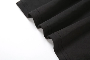 Close-up of black knitted fabric texture with professional double-needle stitching detail