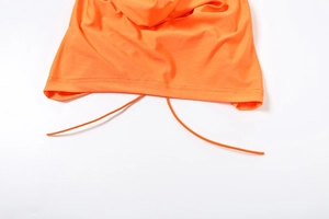 Detail view of the orange hoodie hem showing high-quality stitching and drawstring