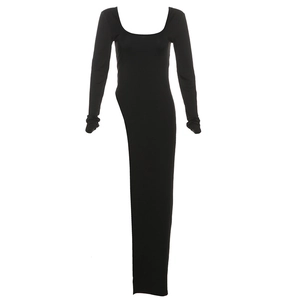 Detail of slim-fit black long sleeve dress with deep U-neck and irregular floor-length hem