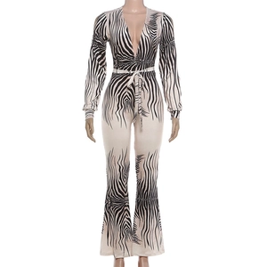 Detail of zebra print jumpsuit featuring a deep V-neck and stylish flared trousers