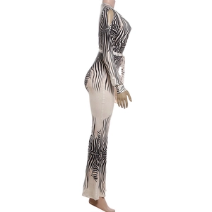 Detail of zebra print jumpsuit with cold shoulder cutouts and waist tie detail