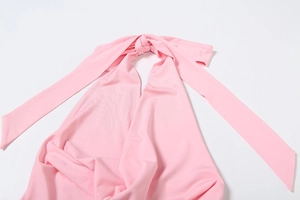 Detail of pink halter neck top showing self-tie closure and soft knitted texture