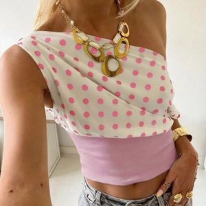 Detail showing the asymmetrical one-shoulder polka dot top with ruched waist texture