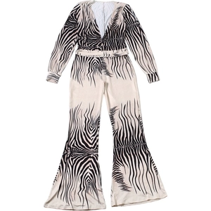 Detail of zebra print jumpsuit with deep V-neck and wide leg flared trousers