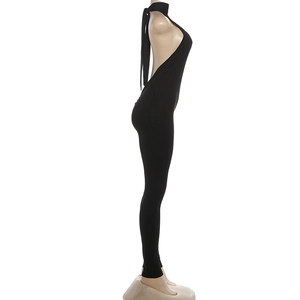 Side view of black halter backless jumpsuit showing slim fit and back cut-out detail