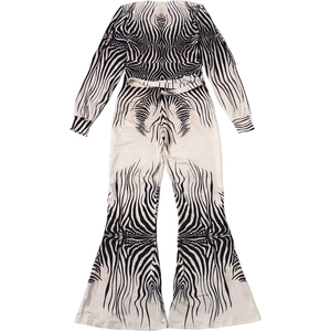 Detail of zebra print jumpsuit with matching waist belt and wide flared leg cuffs