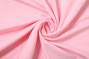 Detailed macro view of soft baby pink knitted fabric with fine diagonal twill texture