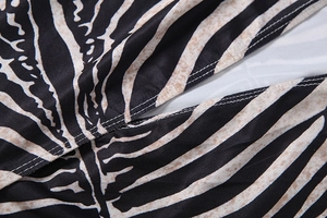 Detailed macro shot of zebra print fabric featuring precision double-needle stitching