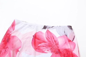 Detailed macro view of vibrant pink floral print on lightweight white mesh fabric