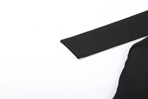 Detailed macro view of black high-density elastic fabric with smooth seams and fine texture